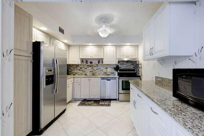 a kitchen with a refrigerator sink and microwave