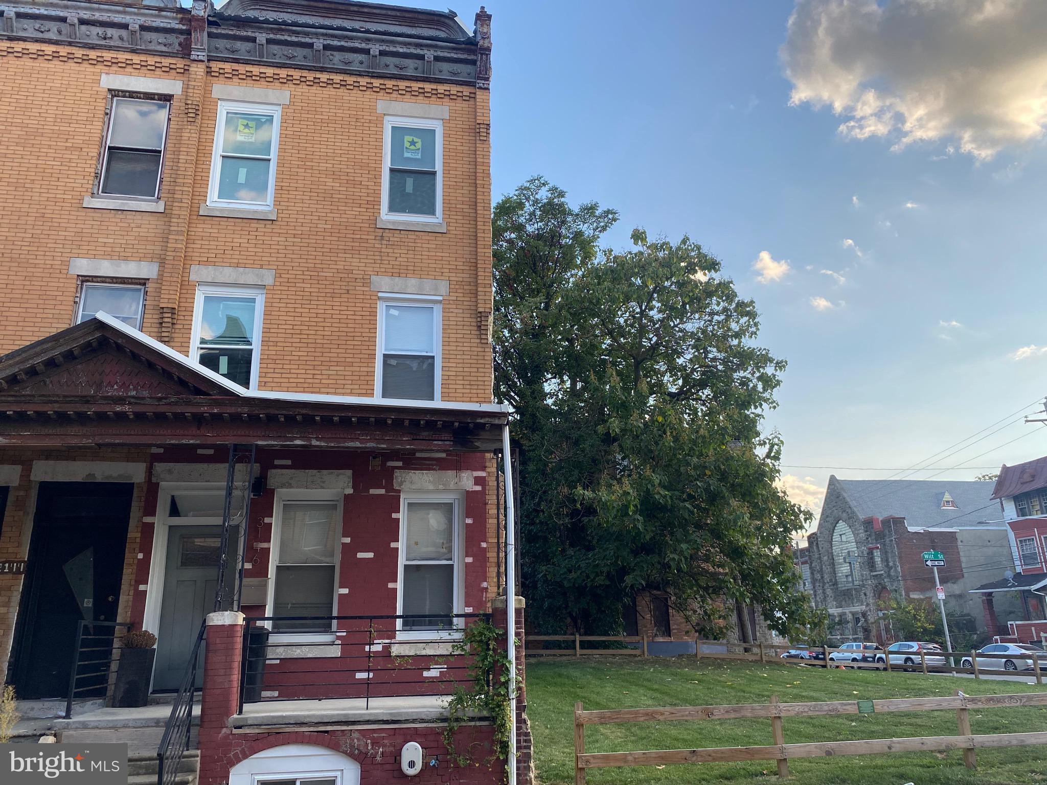 a view of a building with a yard