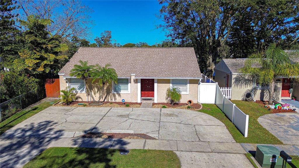 a front view of a house with a yard and outdoor seating