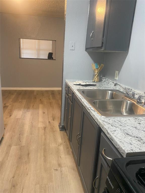 a view storage and utility room with wooden floor