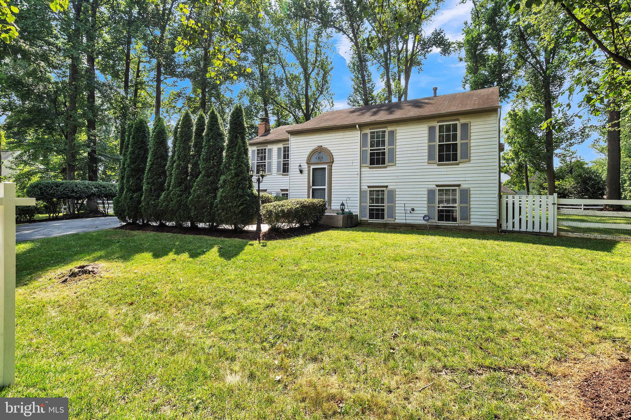 a view of a house with pool and a yard