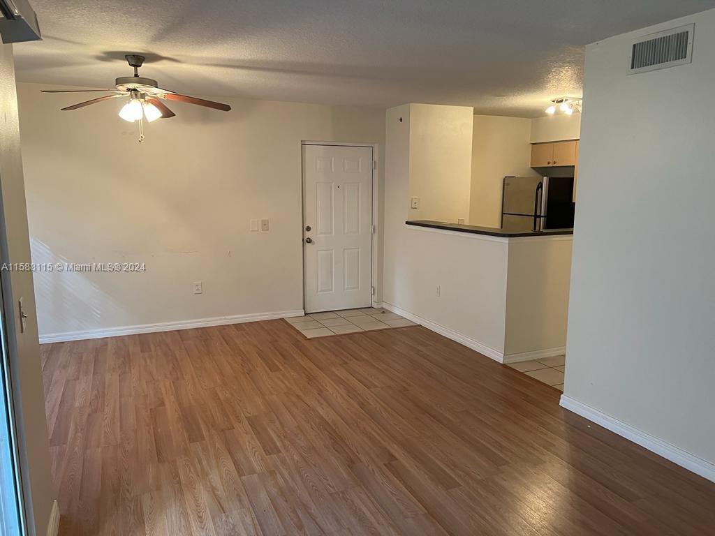 an empty room with wooden floor