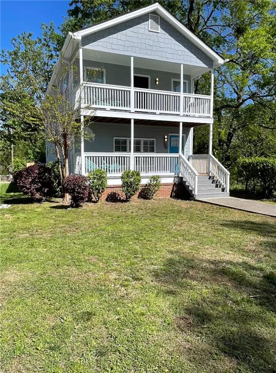 a front view of a house with a garden and porch