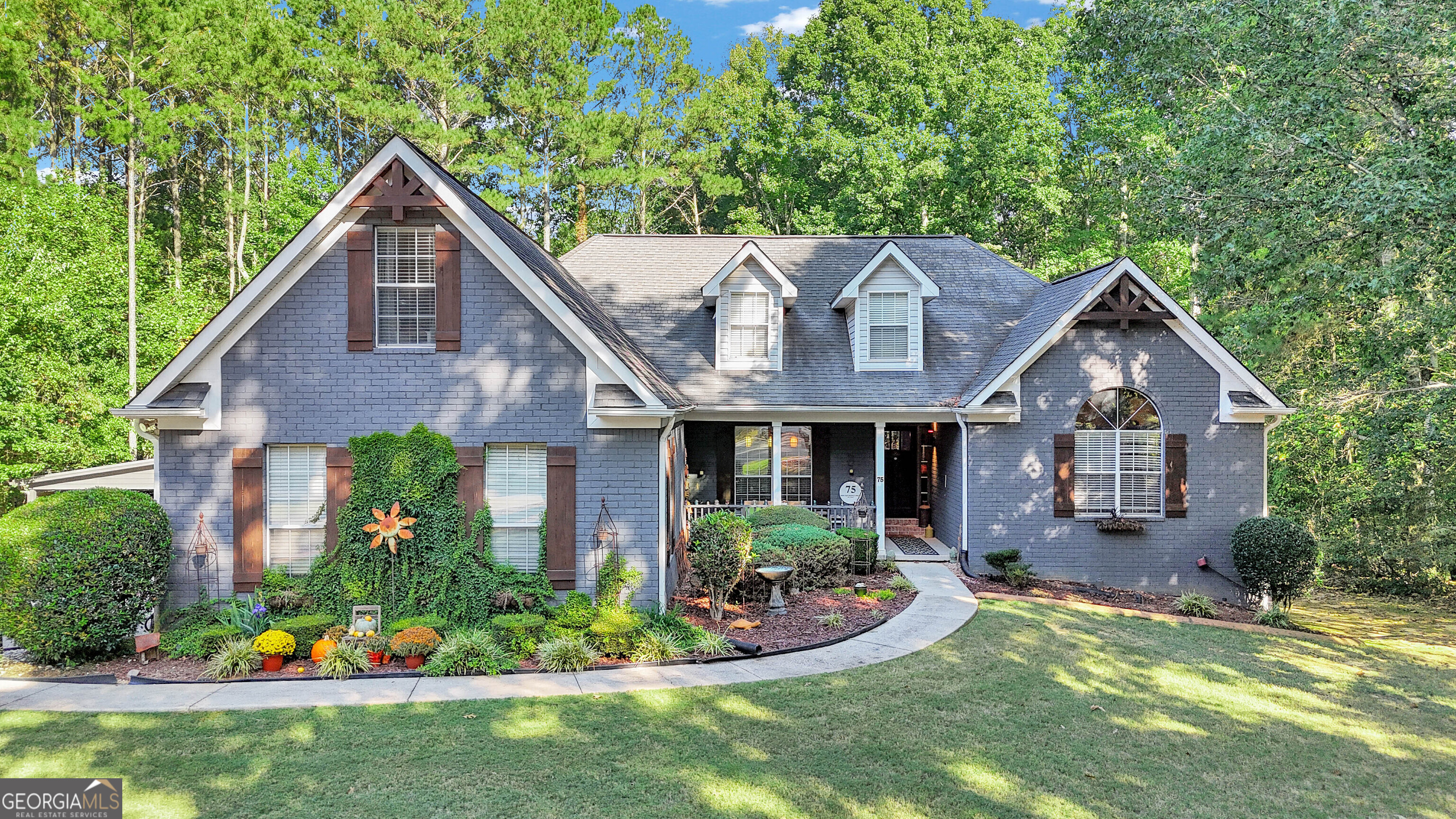 a front view of house with yard and green space