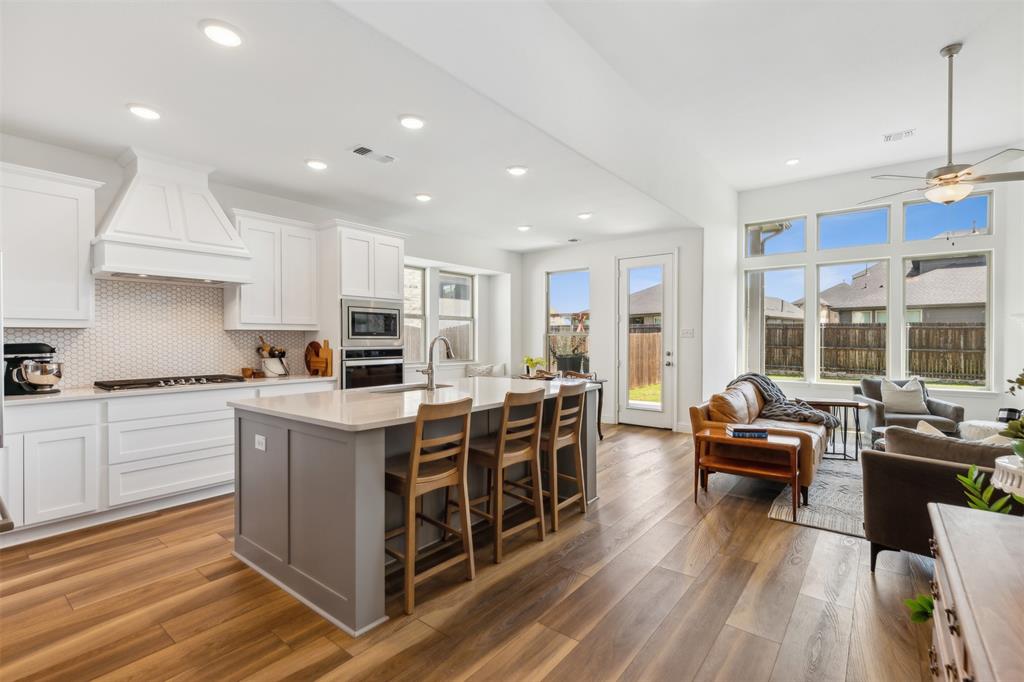 a kitchen with stainless steel appliances granite countertop a stove and a sink