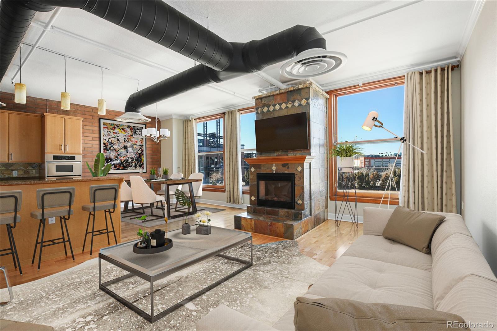 a living room with furniture a flat screen tv and a fireplace