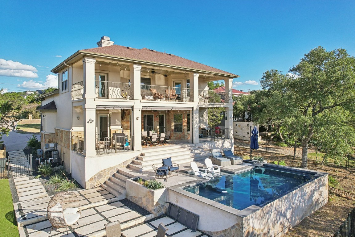 a view of a house with swimming pool in front of it