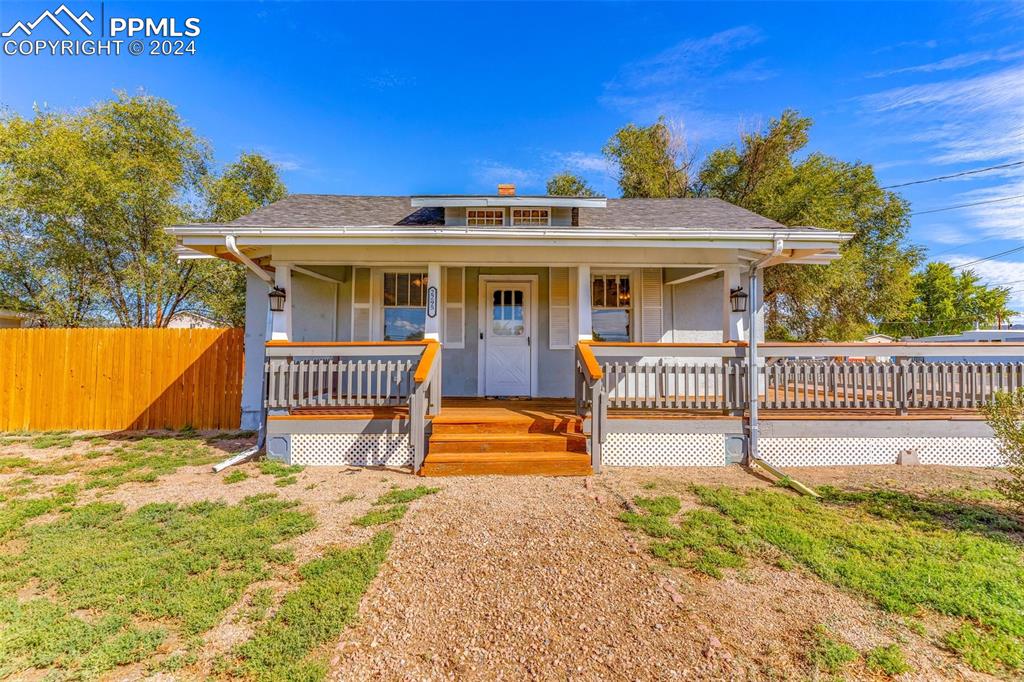 a view of a house with wooden floor and a fence