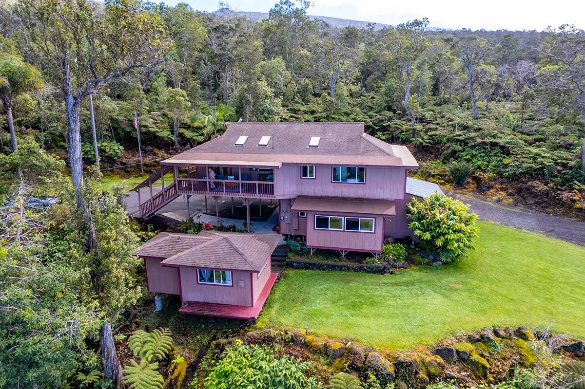 an aerial view of a house with a garden and a yard