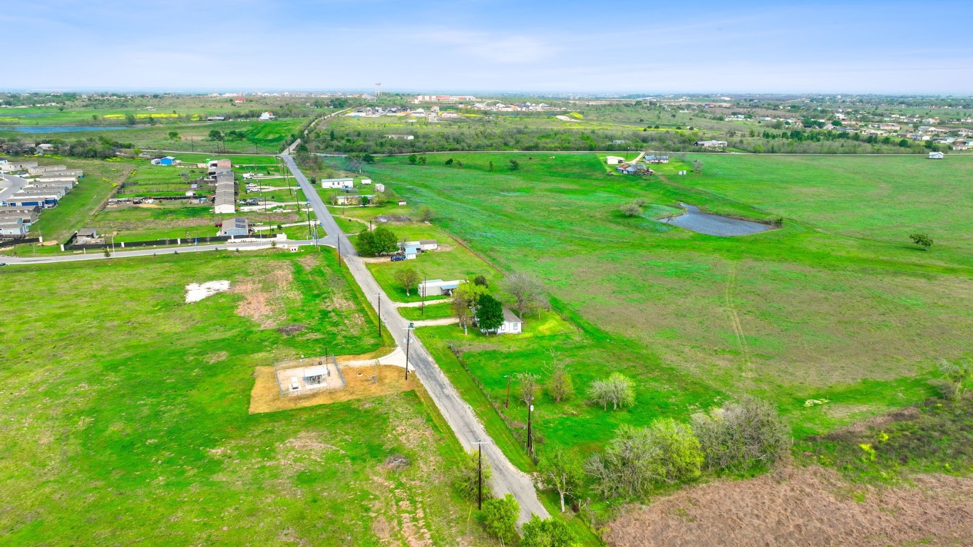 a yard with lots of green space and mountain view in back