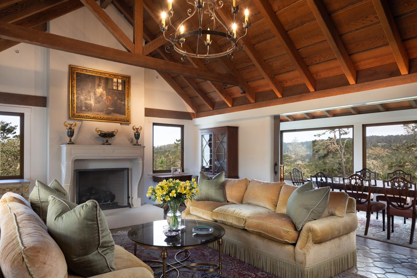 a living room with furniture a fireplace and a large window