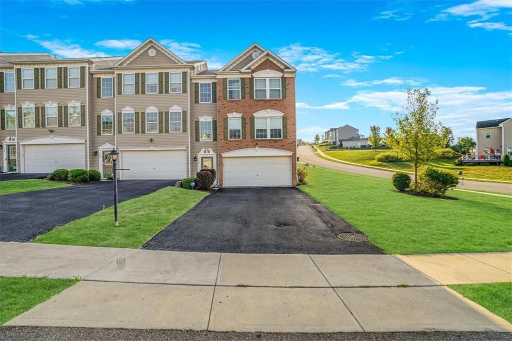 a front view of a house with a yard