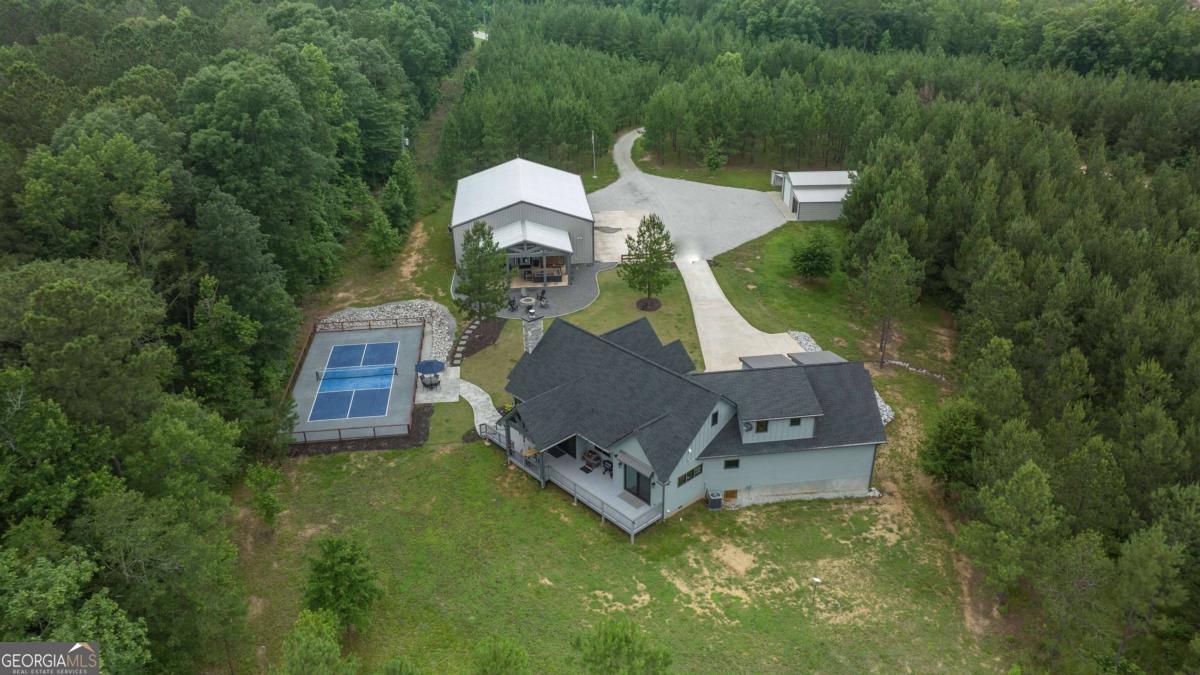 an aerial view of a house with swimming pool and garden