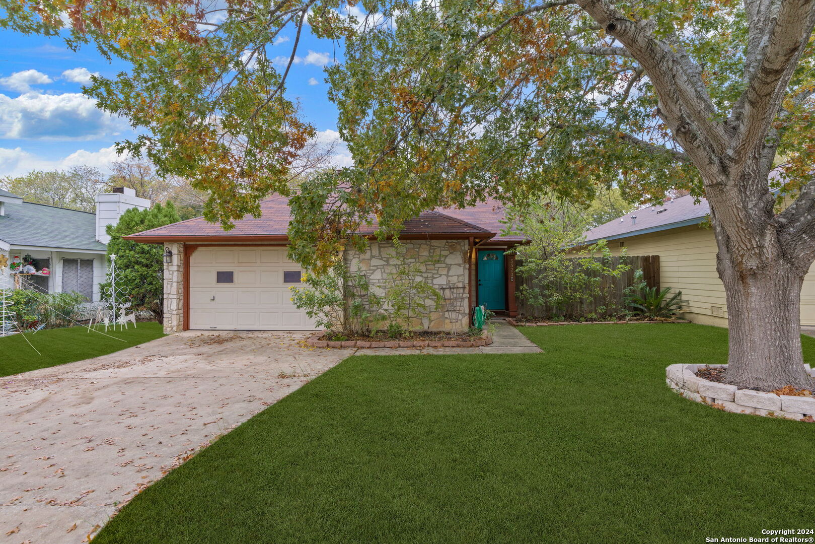 a front view of a house with a garden and yard