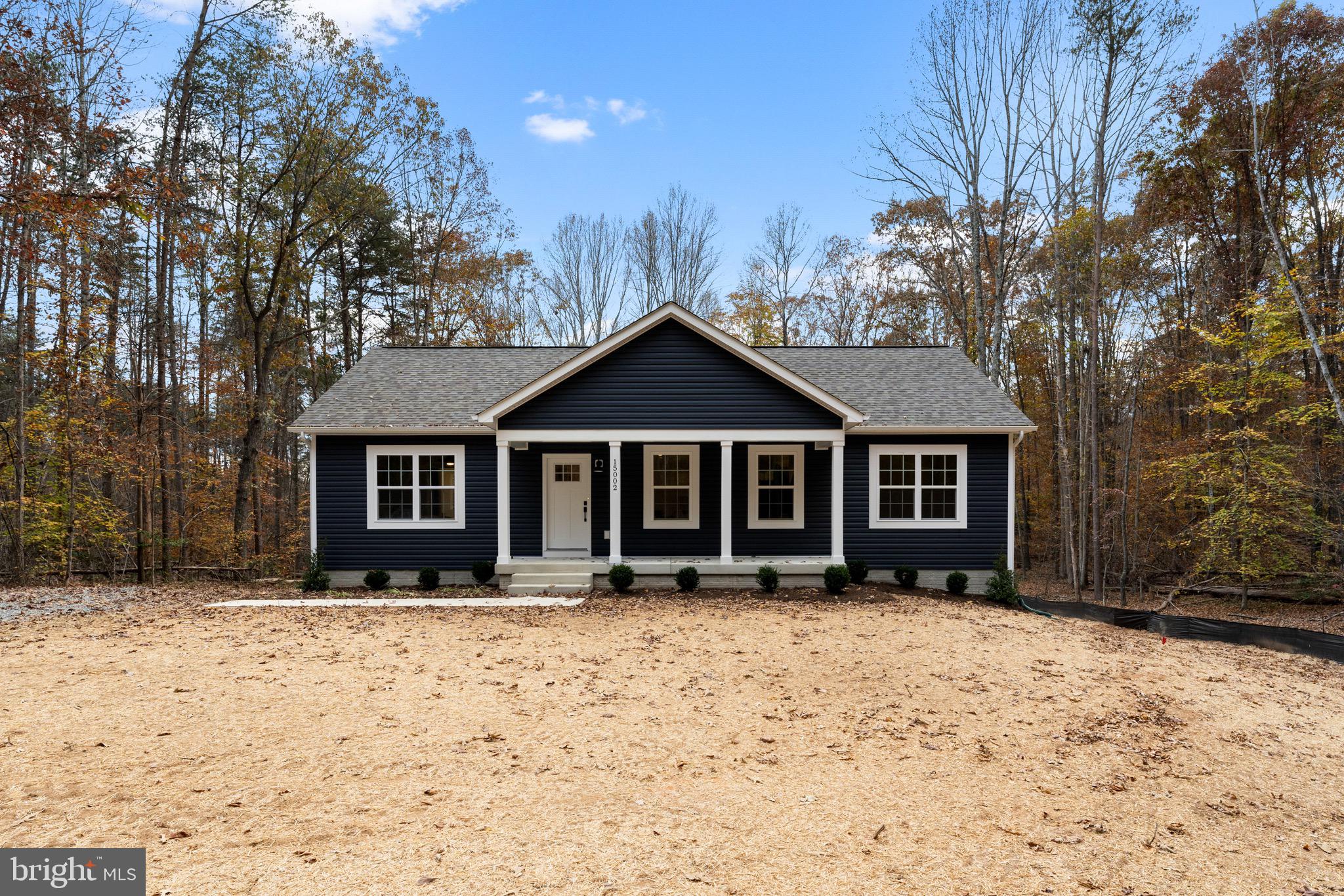 a front view of a house with a yard covered in snow