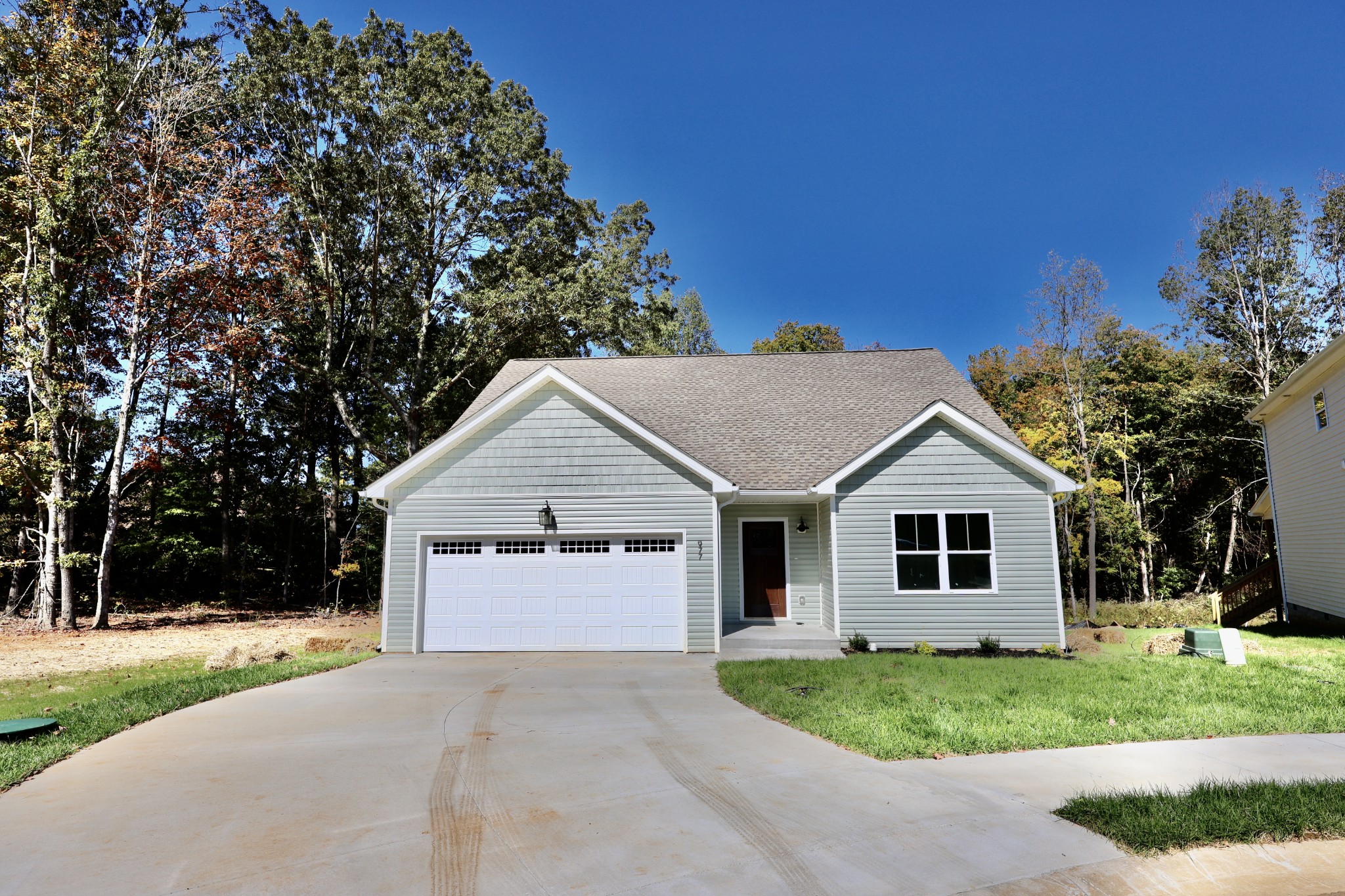 a view of a house with a yard and garage