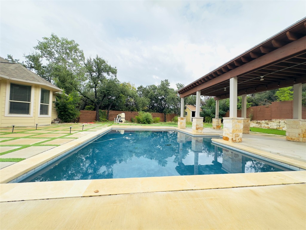 swimming pool view with a seating space