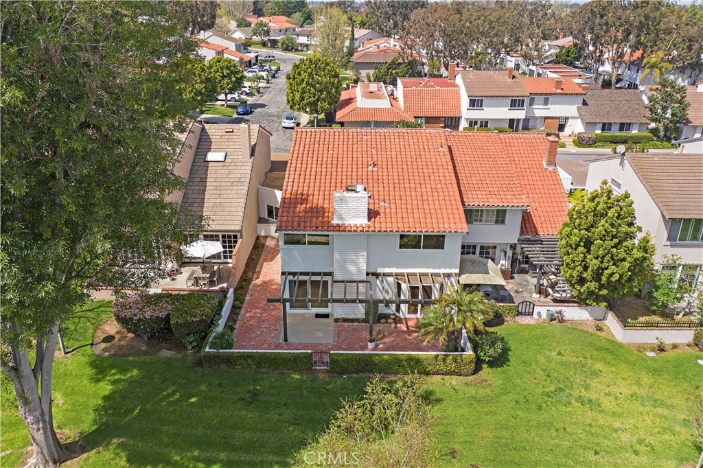 an aerial view of a house with a garden and swimming pool