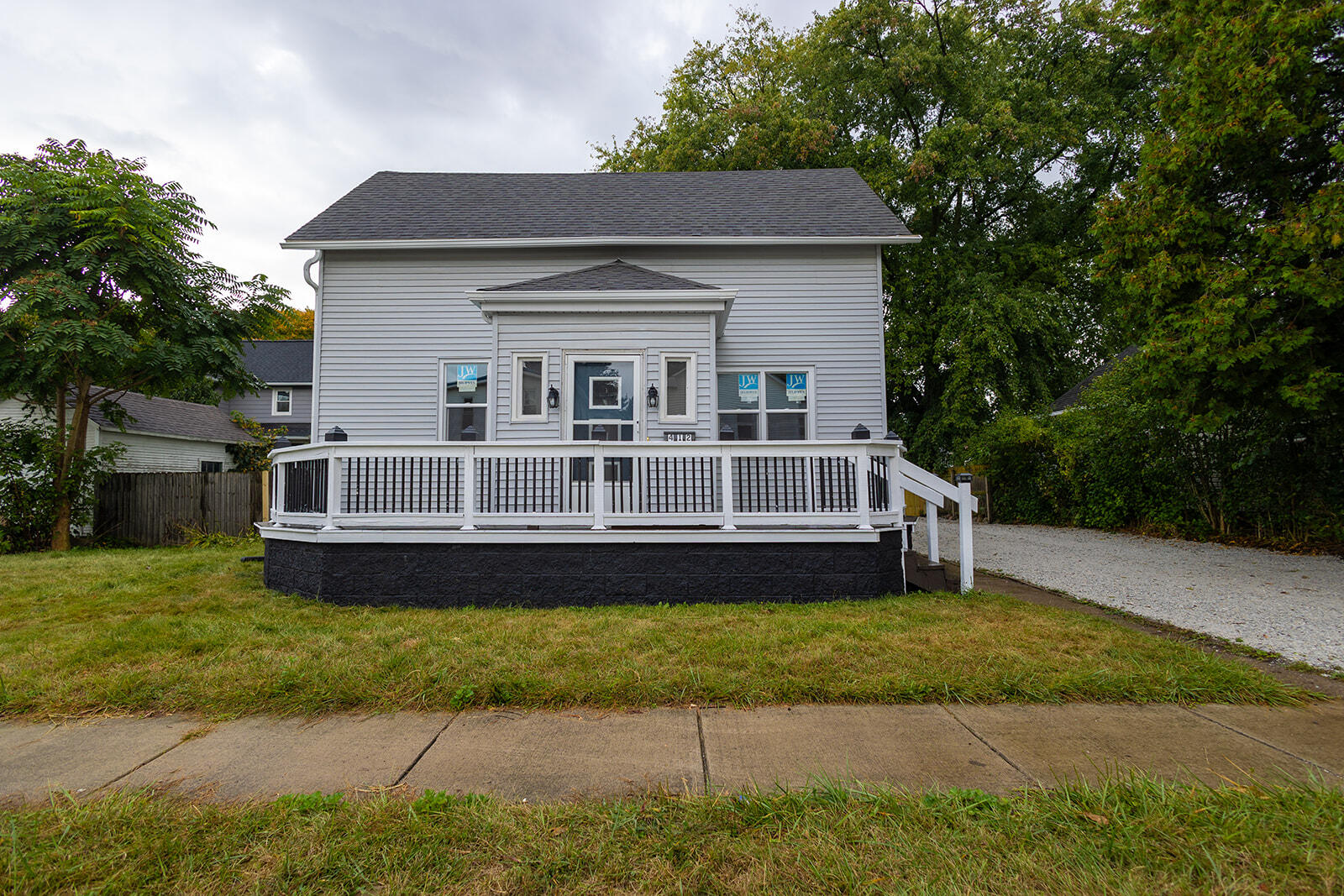 a front view of a house with a garden