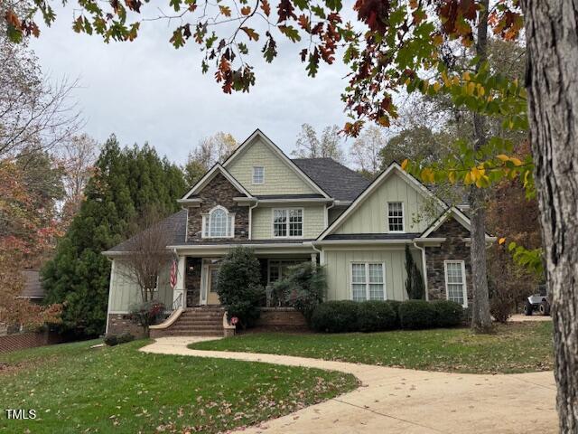 a front view of a house with a garden and trees