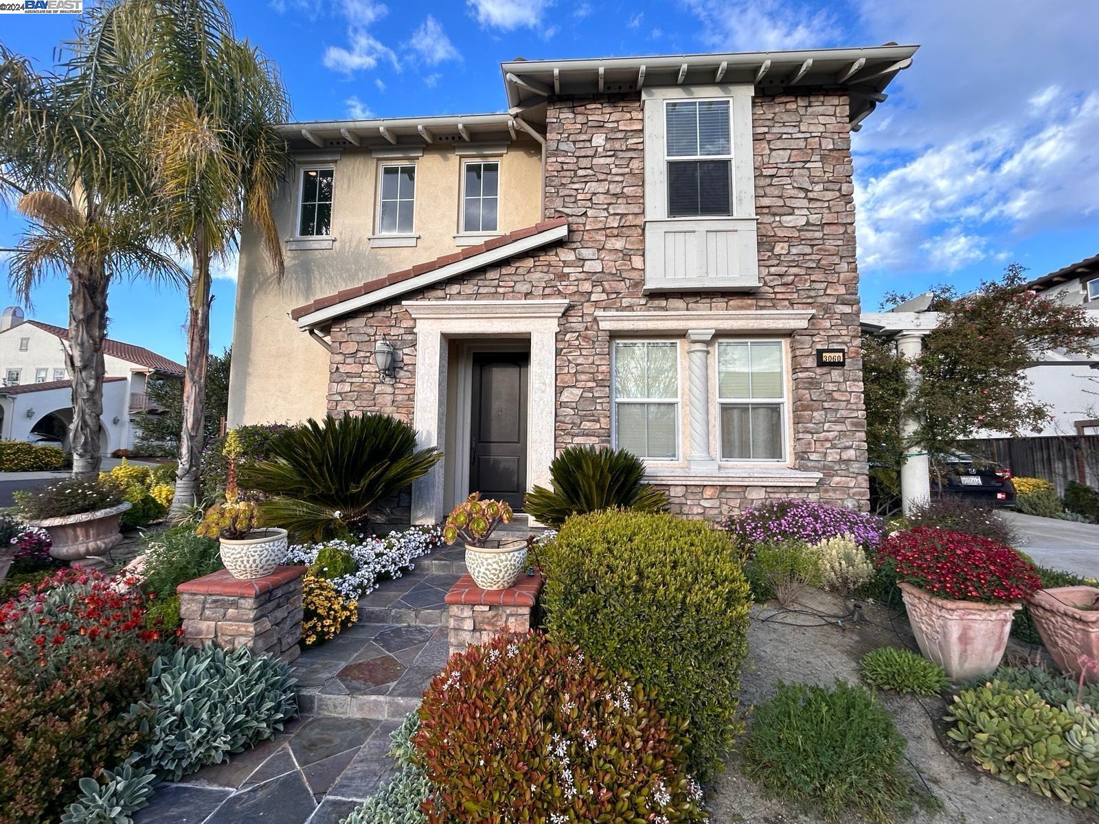 a front view of a house with a yard and outdoor seating