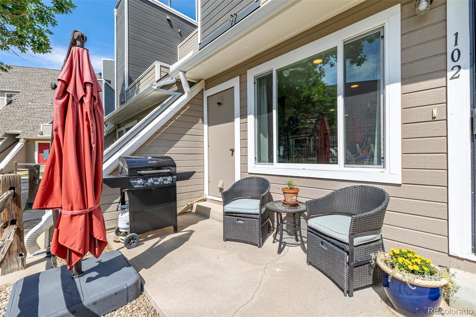 a backyard of a house with outdoor seating