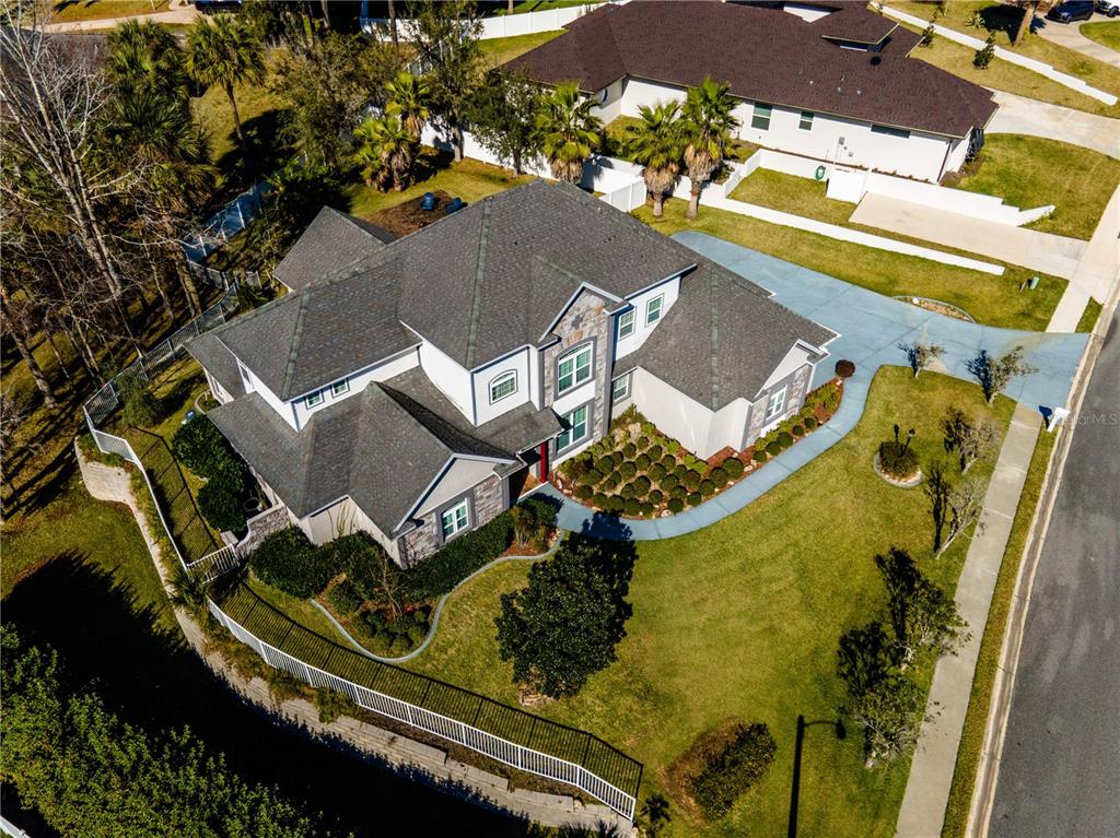 an aerial view of a house with a swimming pool and outdoor seating