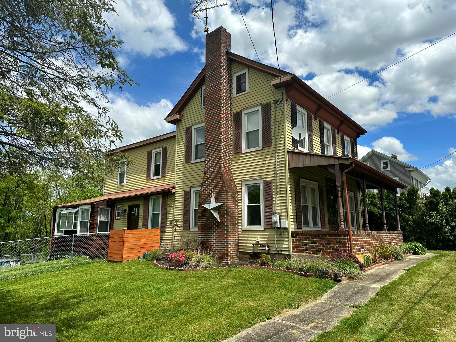 a front view of a house with a yard and porch