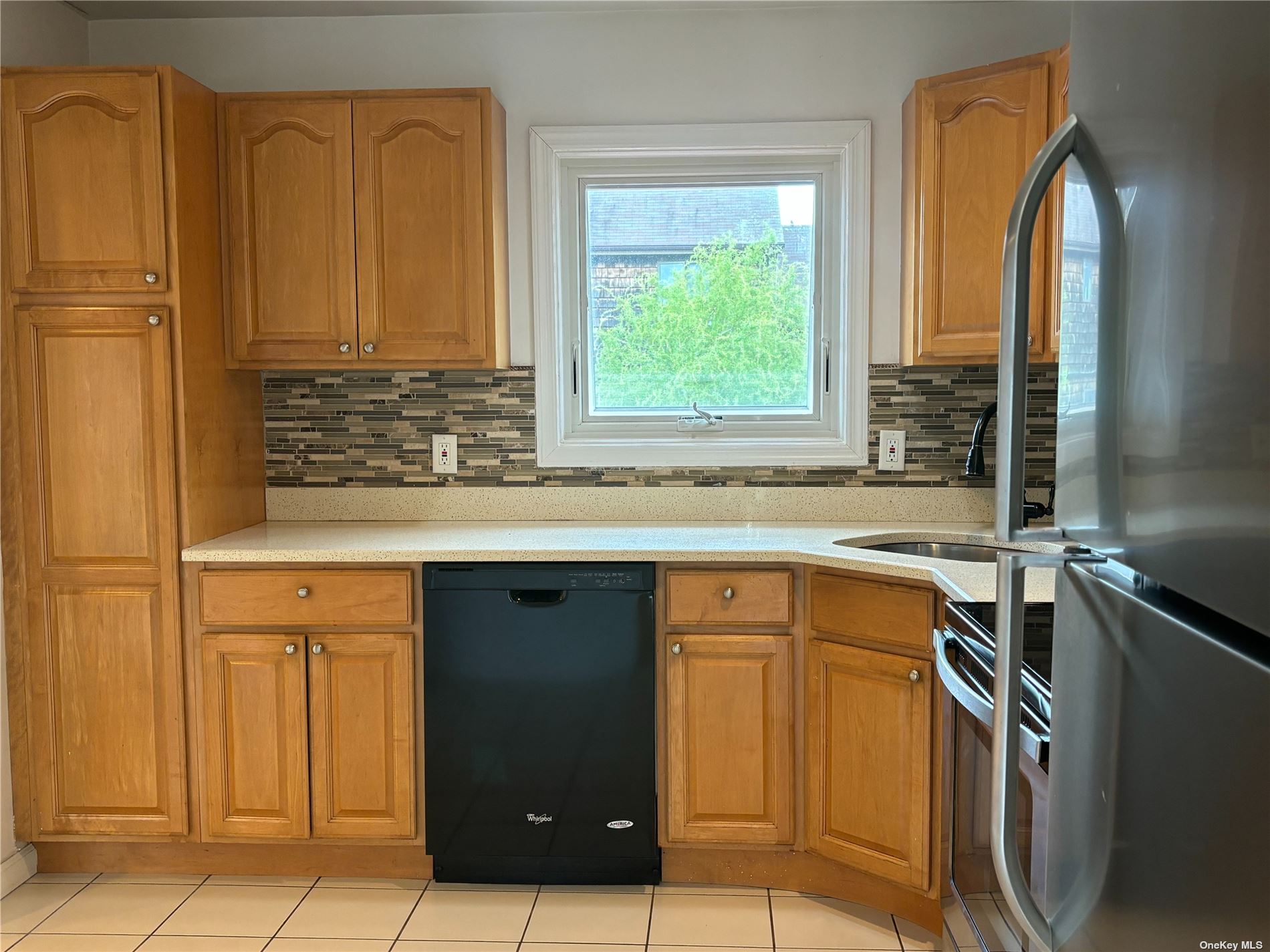 a kitchen with a sink cabinets and wooden floor