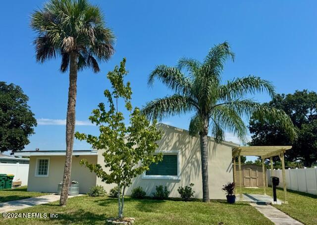 a view of a palm trees in a yard with swimming pool