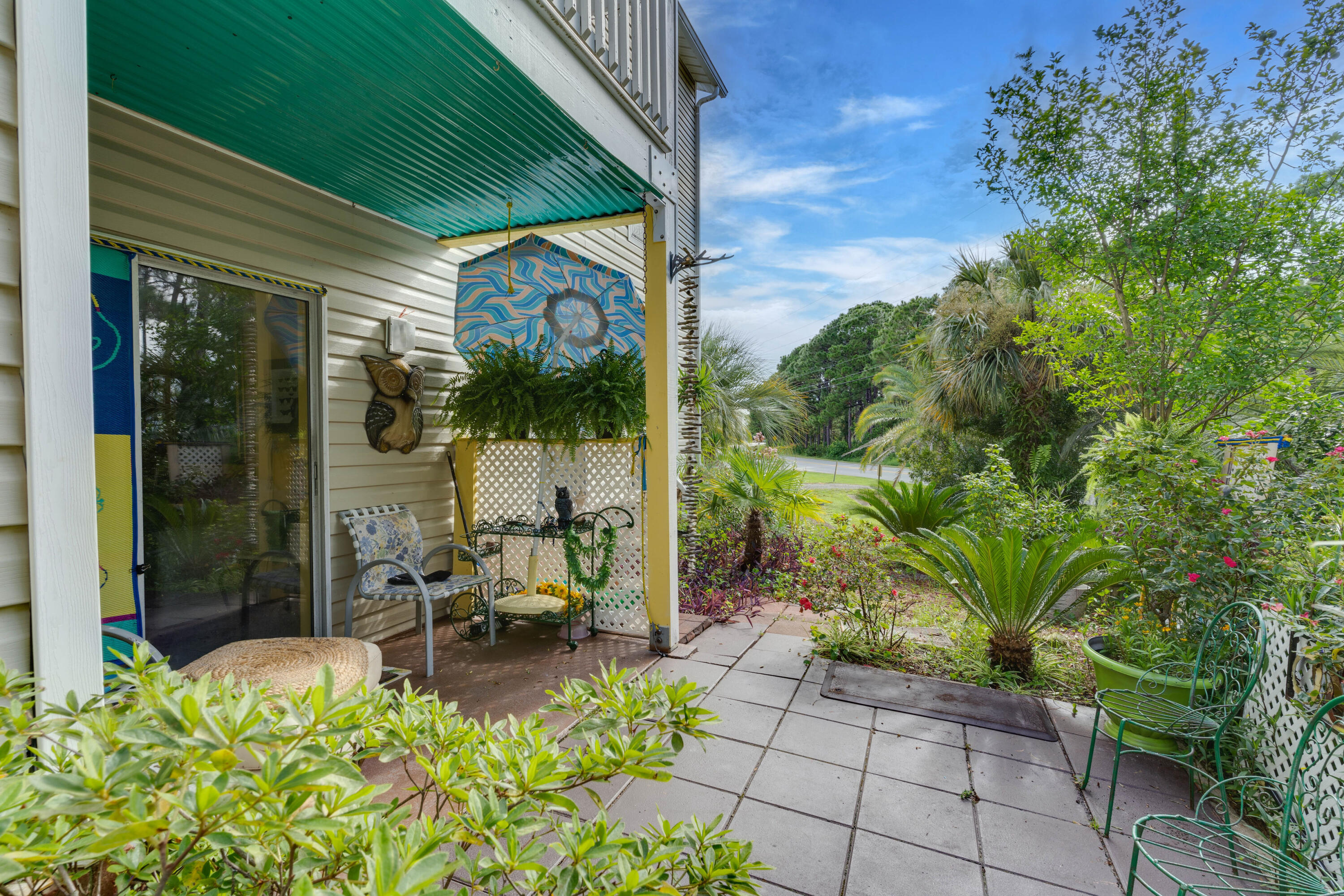 a view of a patio with table and chairs and potted plants