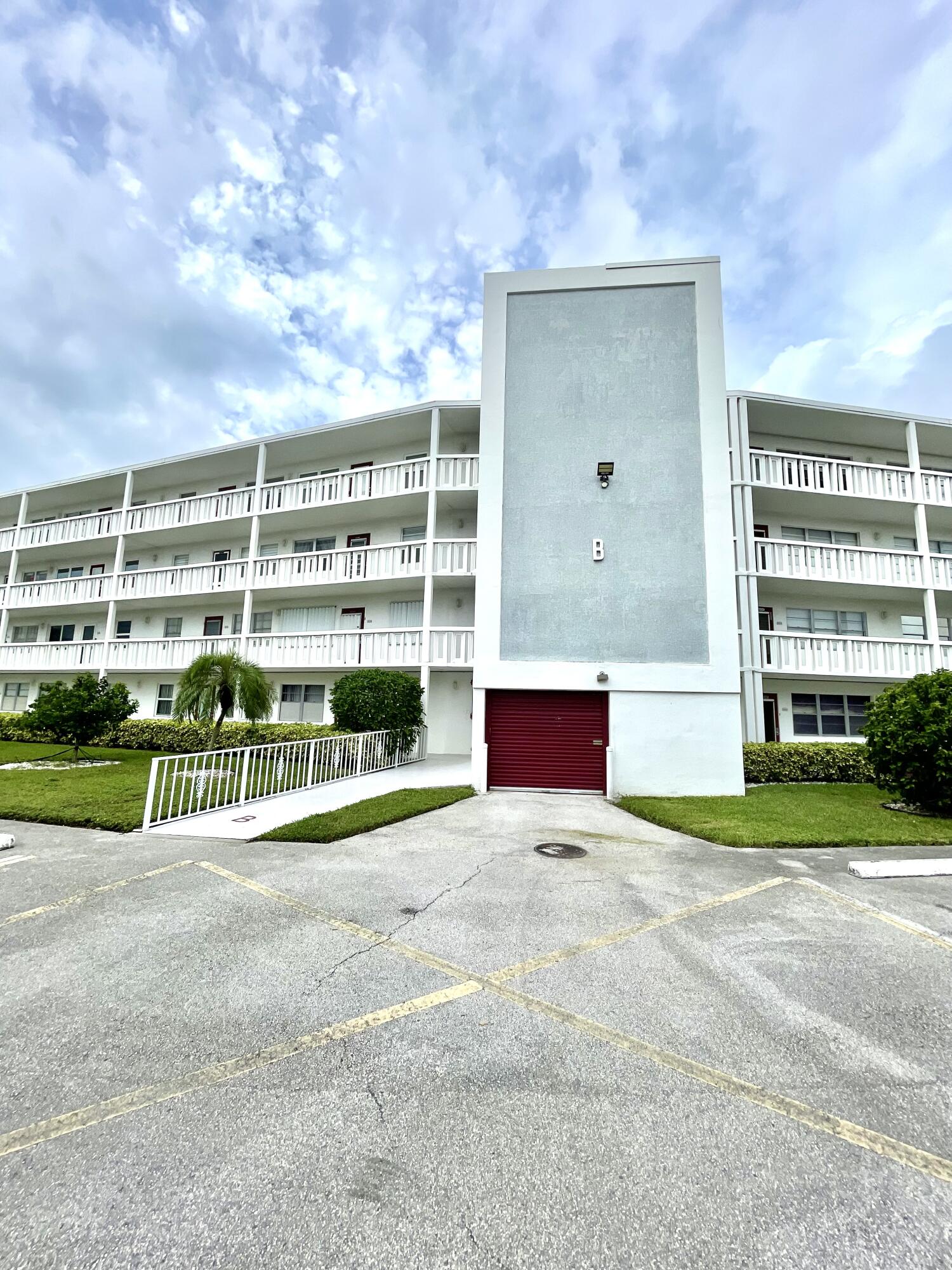 a view of building with yard and sign board