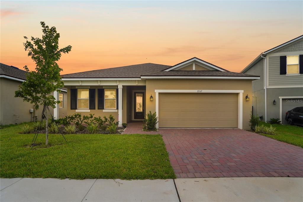 a front view of a house with a yard and garage