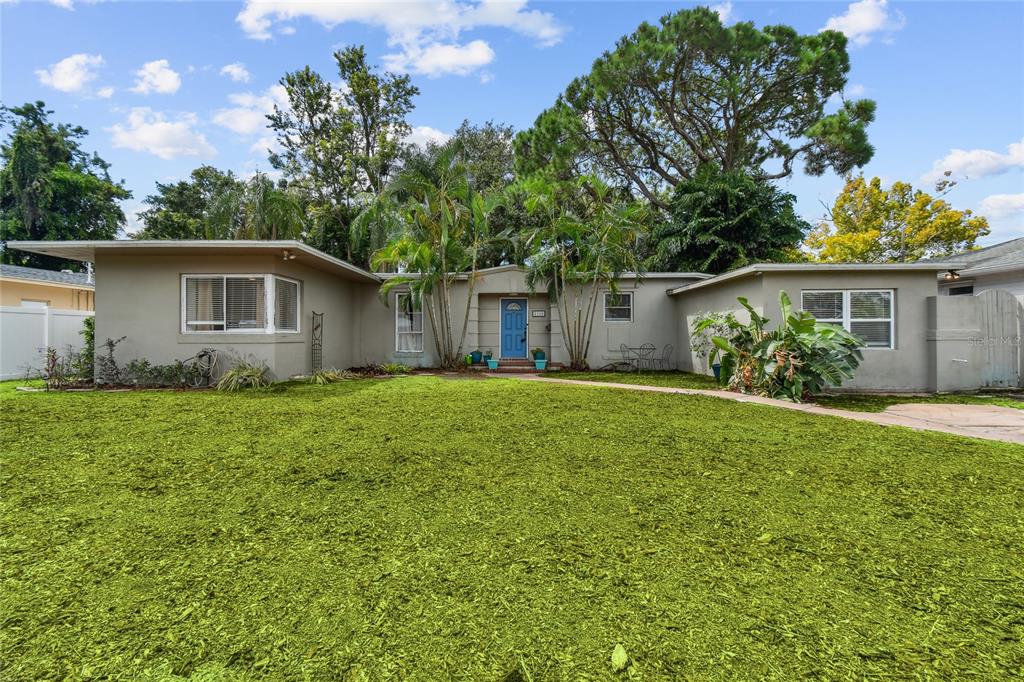 a front view of house with yard and trees