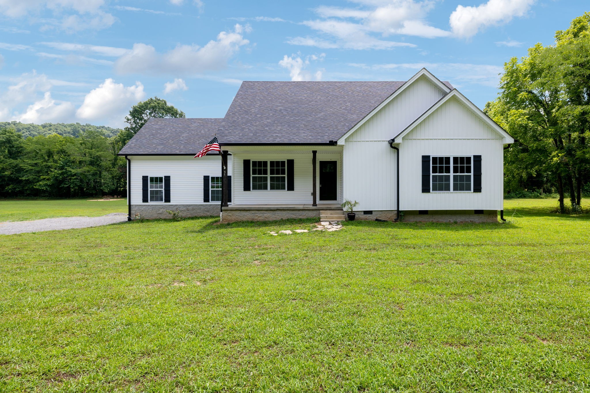 a front view of house with yard and green space