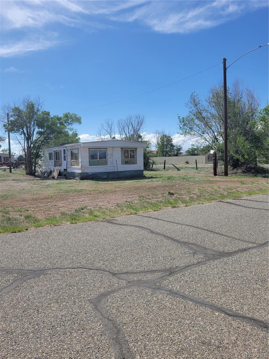 front view of a house with a yard and a street view