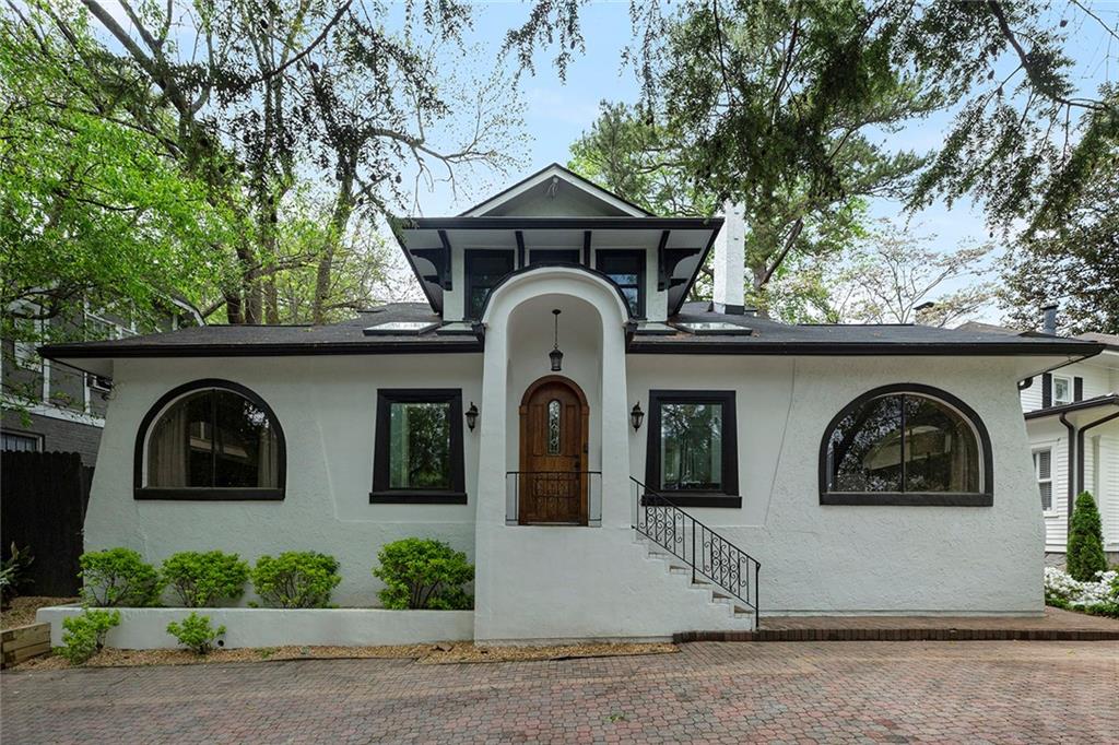 a front view of a house with a garden