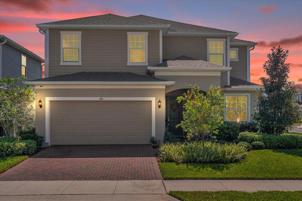 a front view of a house with a yard and garage