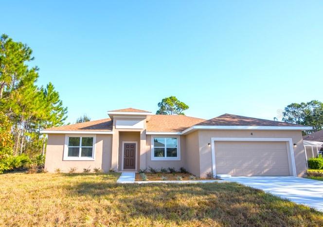 a view of a yard in front of a house with garage