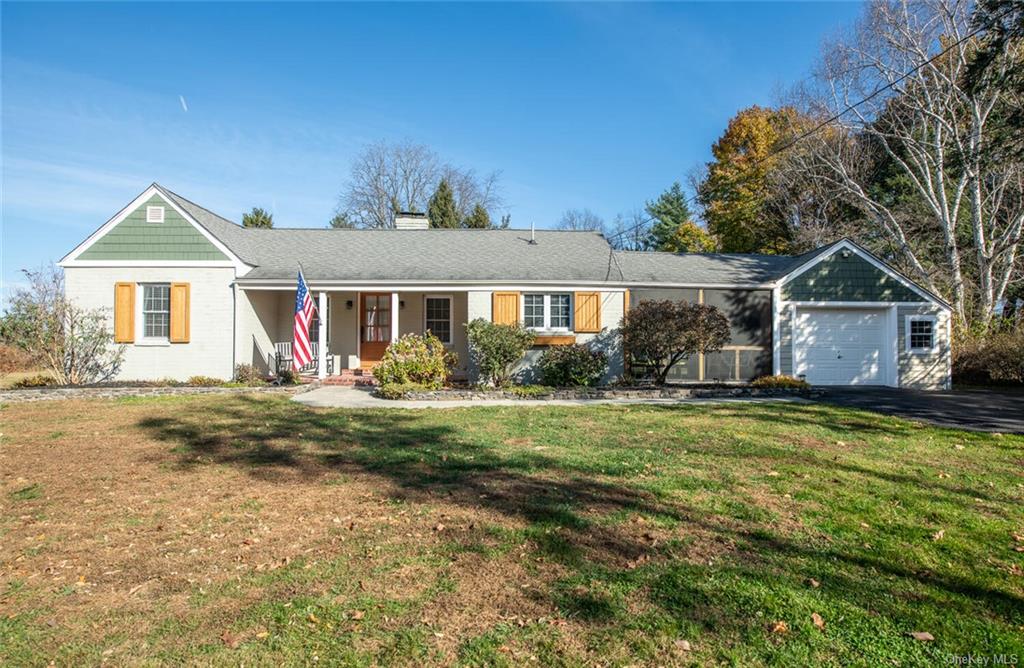 Single story home with a front yard, a porch, and a garage