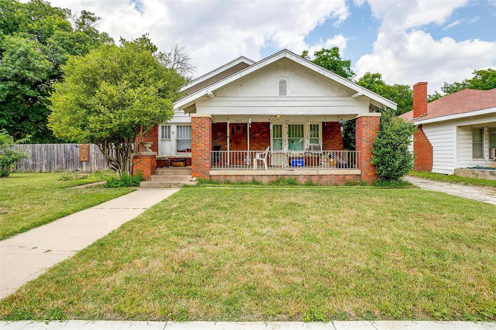 a front view of a house with a yard patio and fire pit