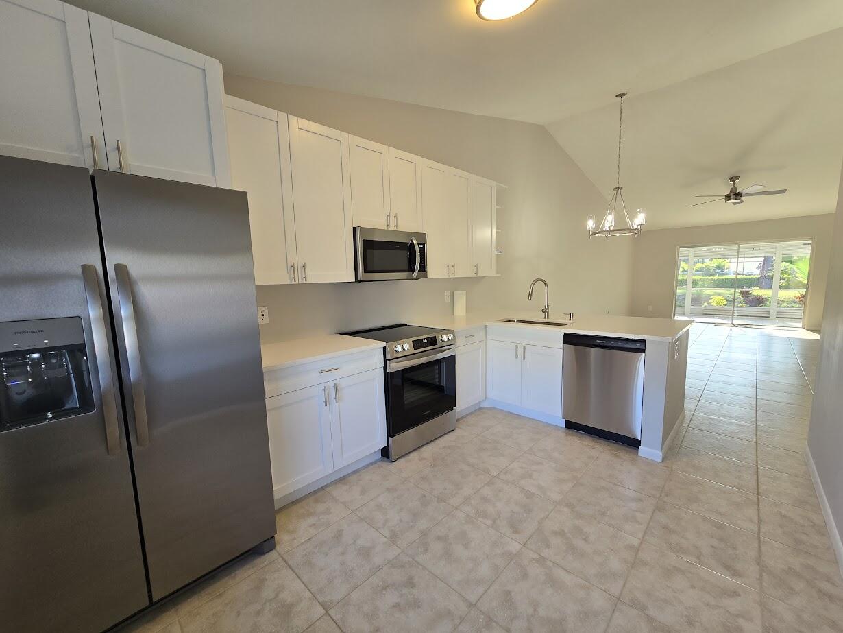 a kitchen with a refrigerator and a stove