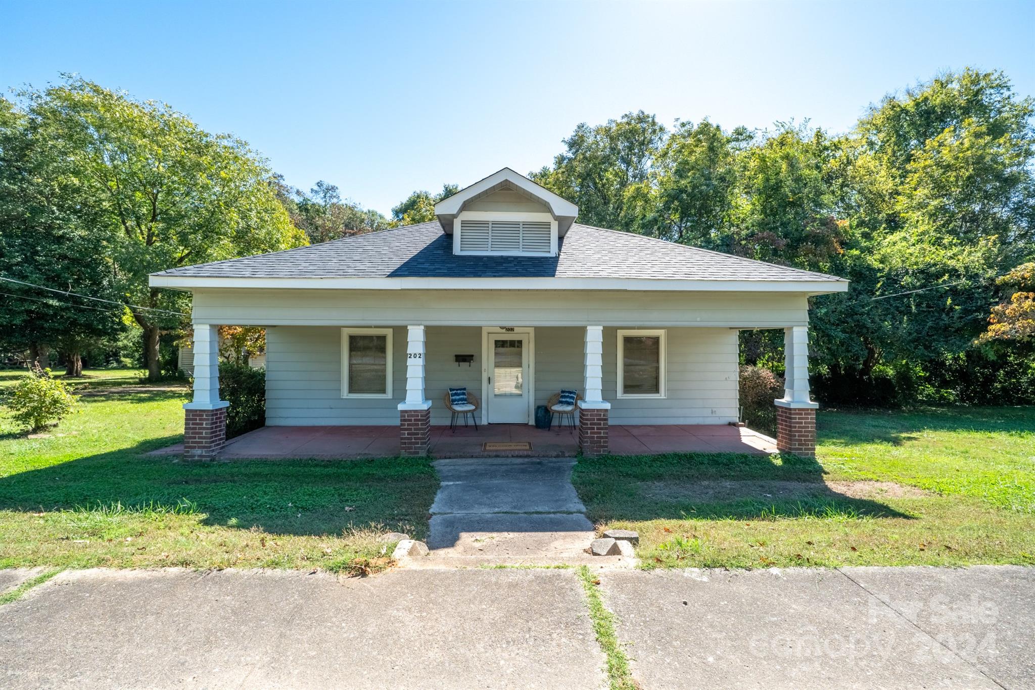 a front view of a house with a yard and porch