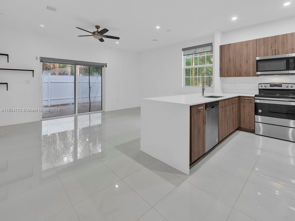 a kitchen with stainless steel appliances a sink stove and cabinets