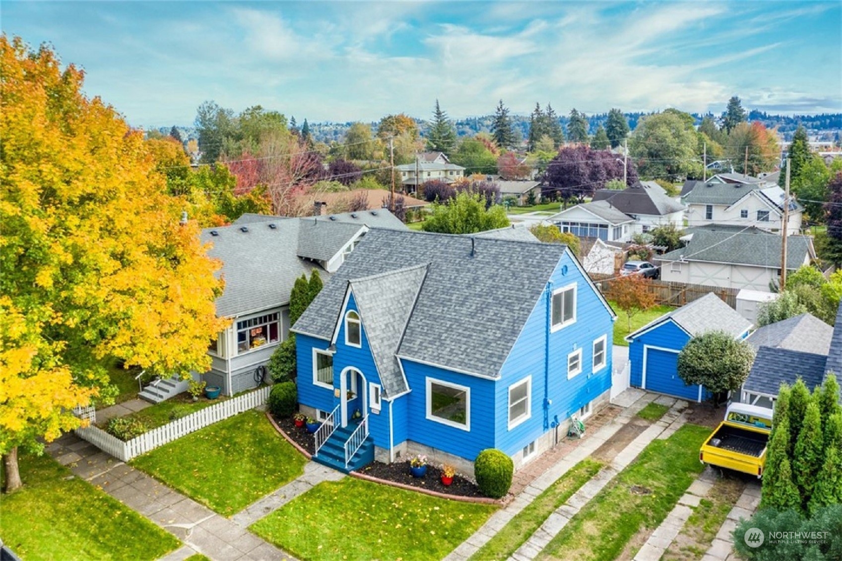 a aerial view of a house with a yard basket ball court and outdoor seating