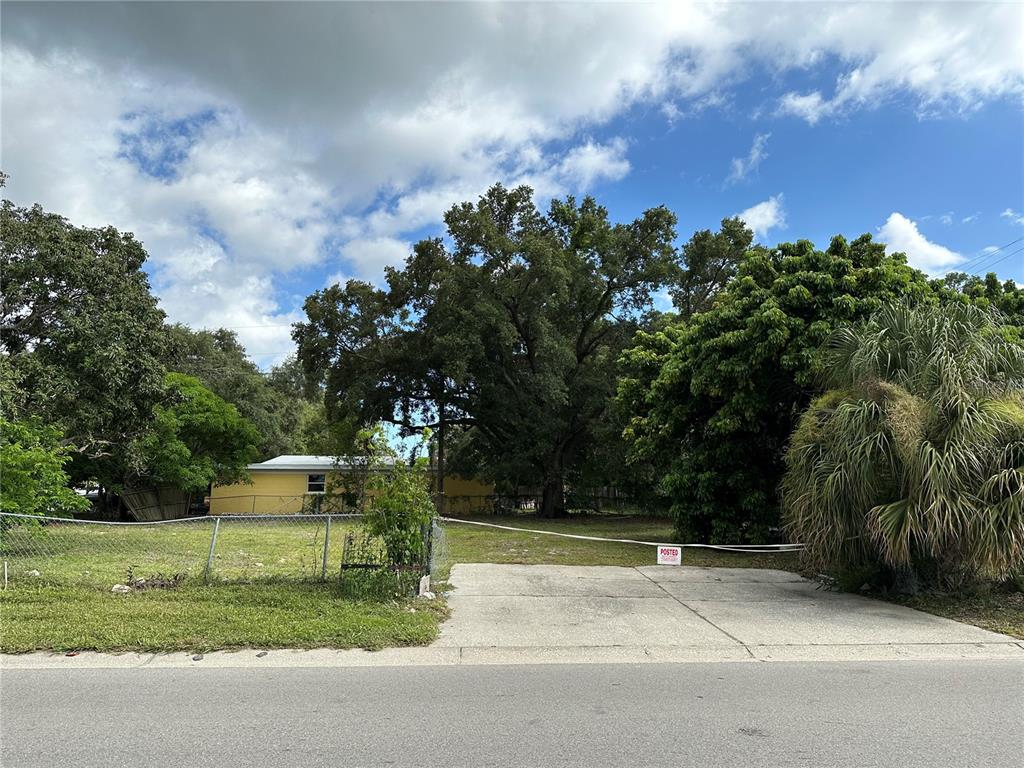 a view of a house with a yard and a garden