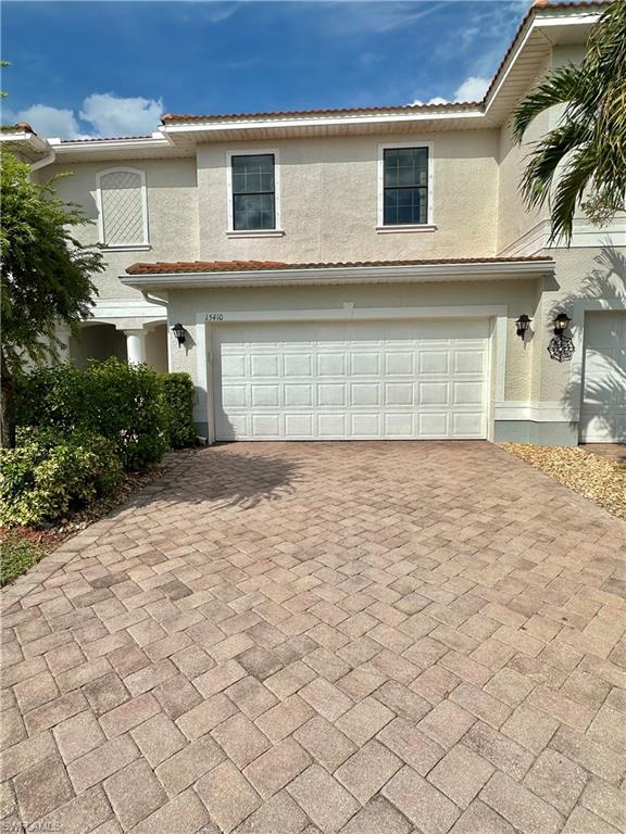 a view of a house with a yard and garage