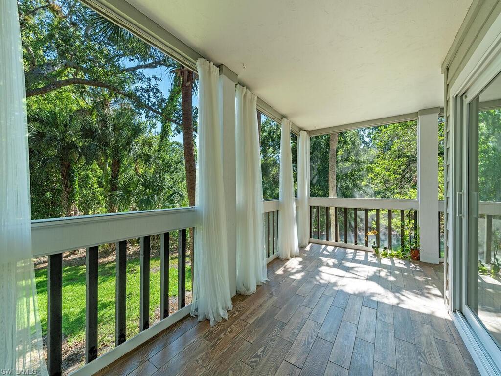 a view of a balcony with wooden floor