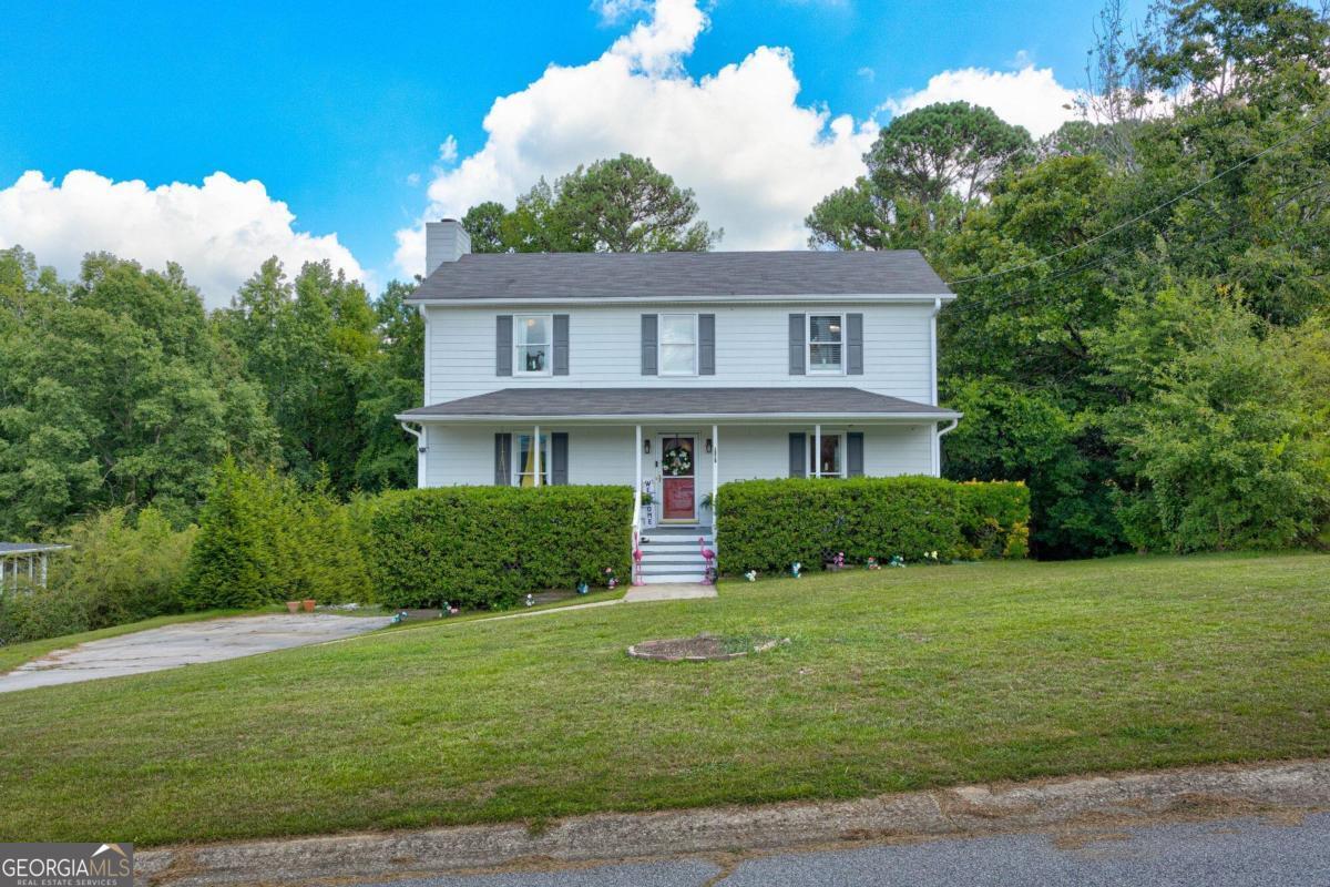 a front view of a house with a yard