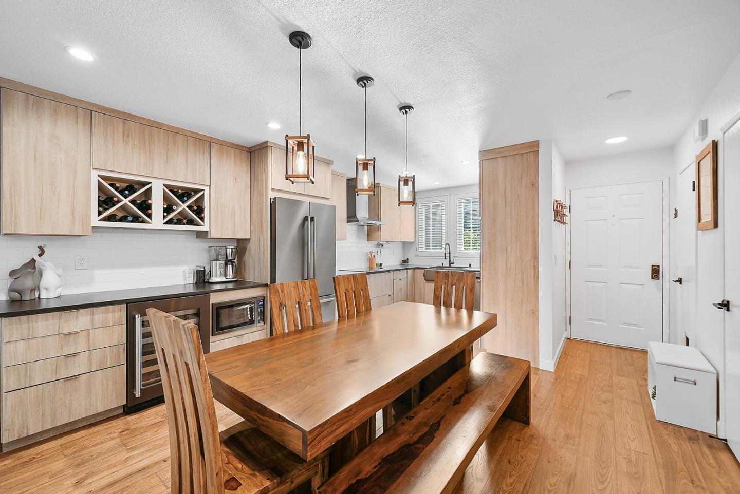 a large kitchen with a table and chairs